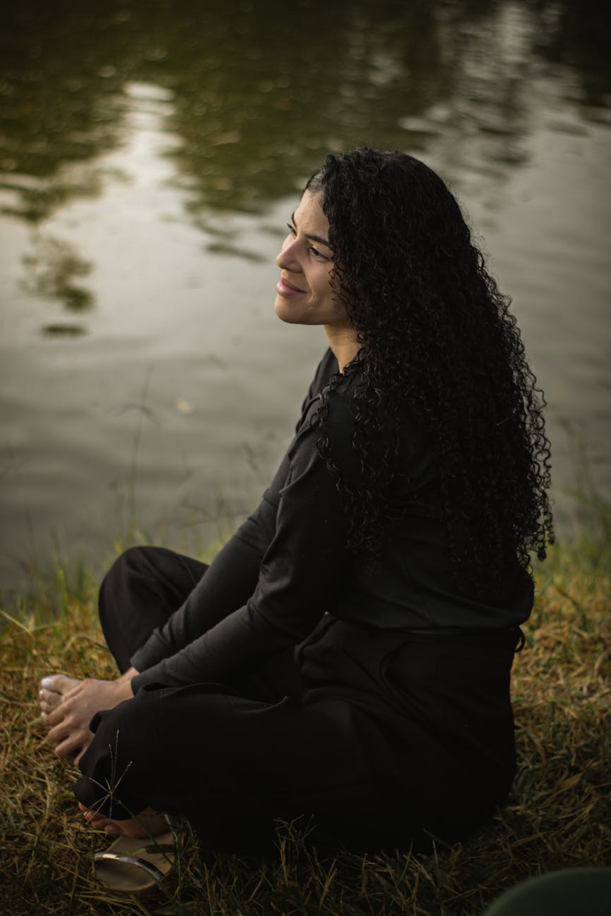 serene woman gazing at lake in tranquil setting