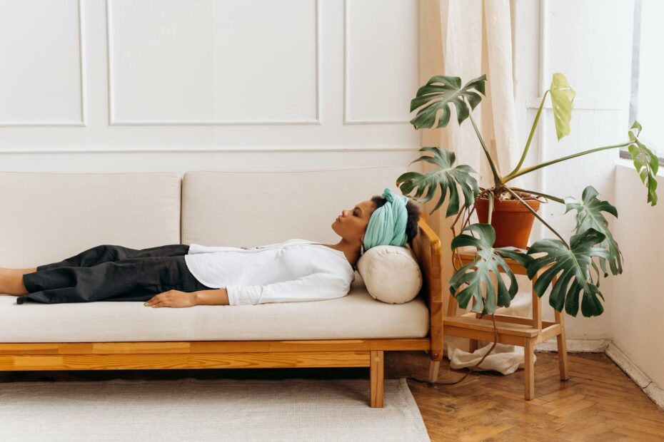 a woman lying straight body on a couch